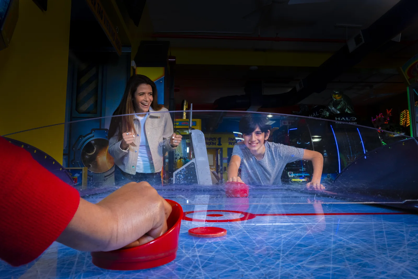 Guests playing air hockey at Laser Bounce