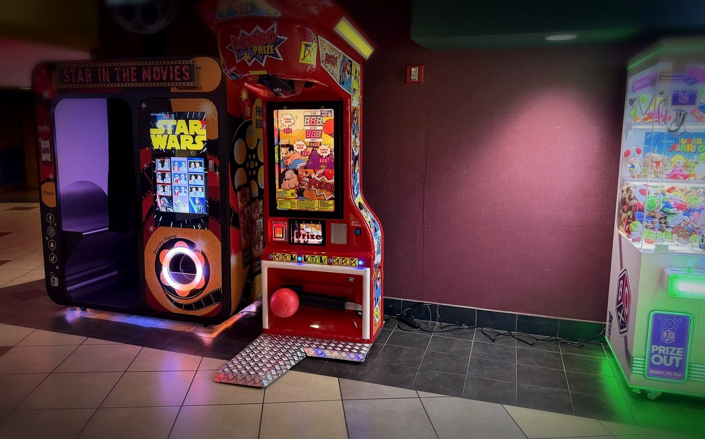 Claw machines along a theater lobby wall