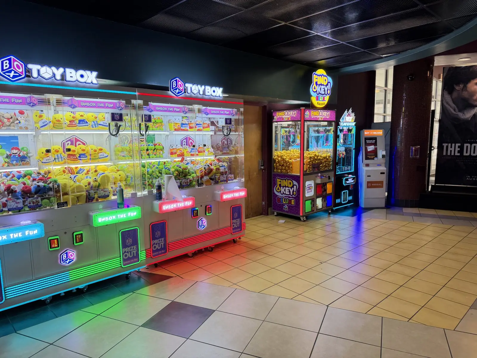 Toy Box claw machines and prize games installed by The Arcade Pros in a Regal theater lobby