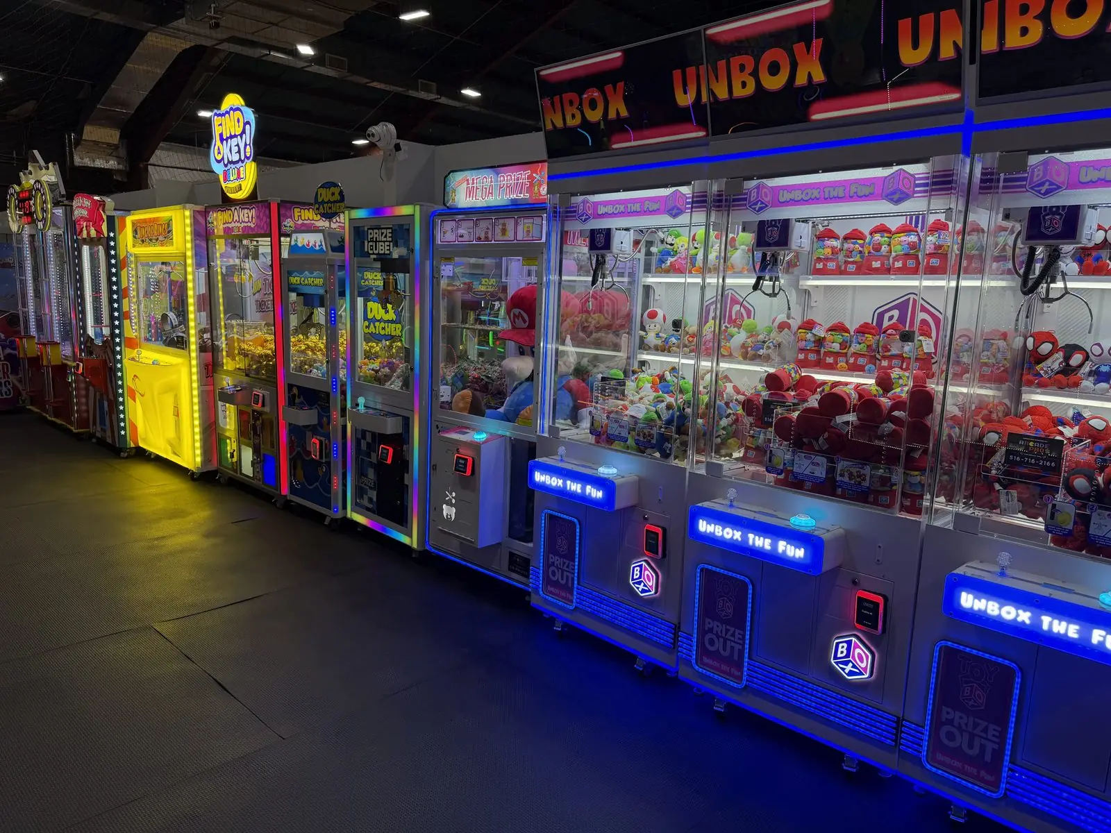 Row of Unbox and prize claw machines placed by The Arcade Pros at a Sky Zone trampoline park
